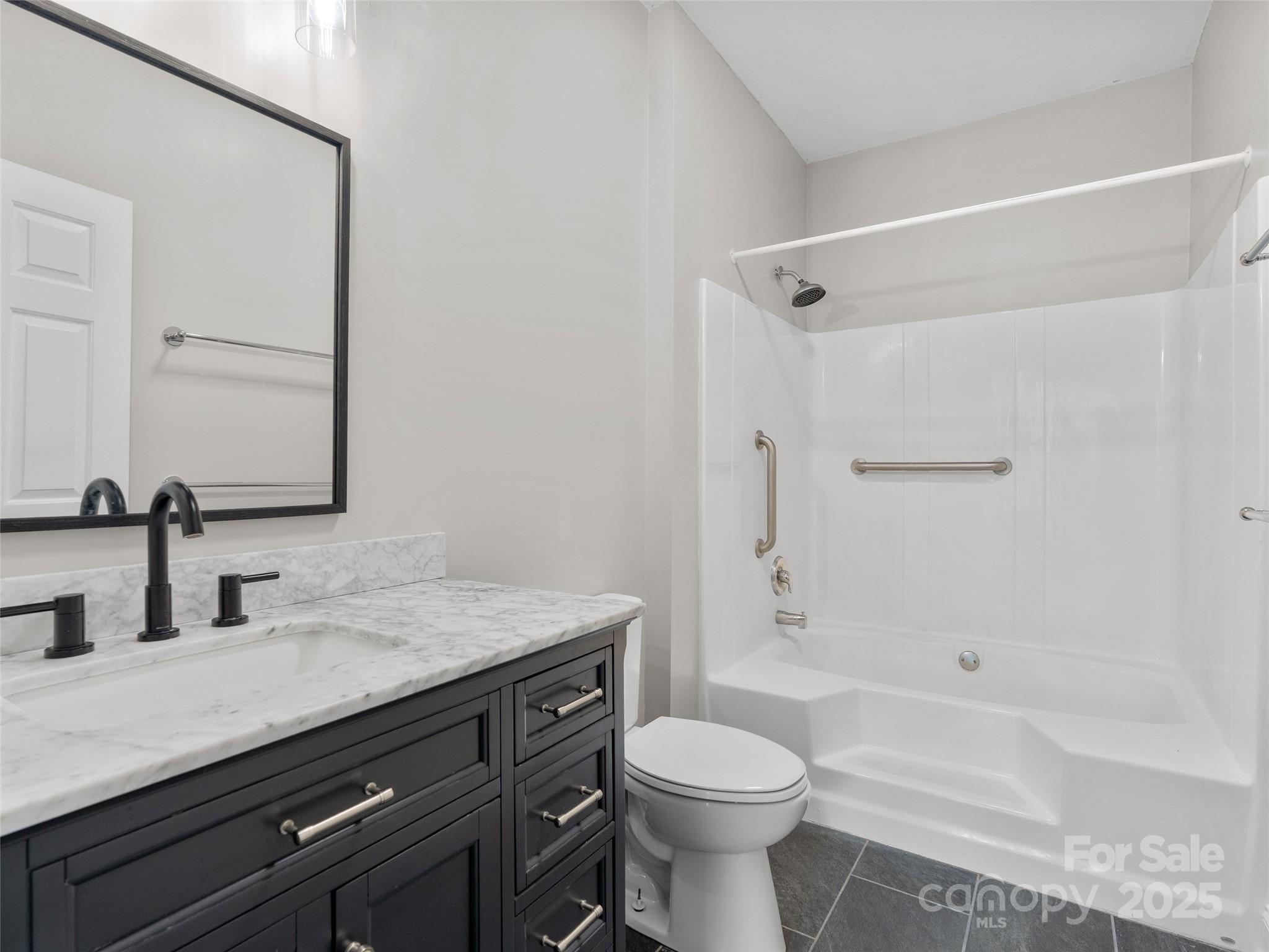 99 Curtis Parker Road Alexander, NC 28701 - Photo 11 of 24 a bathroom with a sink a toilet and shower