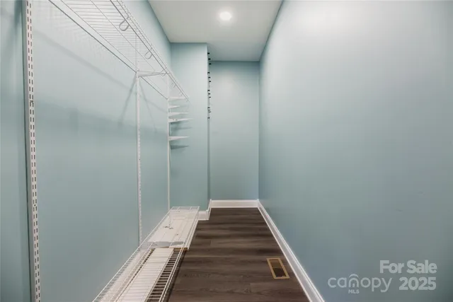 a view of hallway with wooden floor