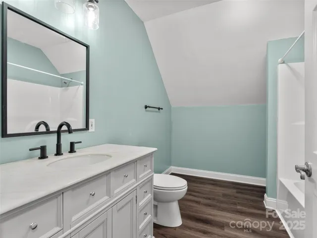 a bathroom with a sink a toilet and mirror