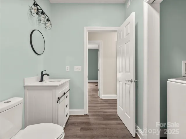 a bathroom with a toilet a sink and a mirror