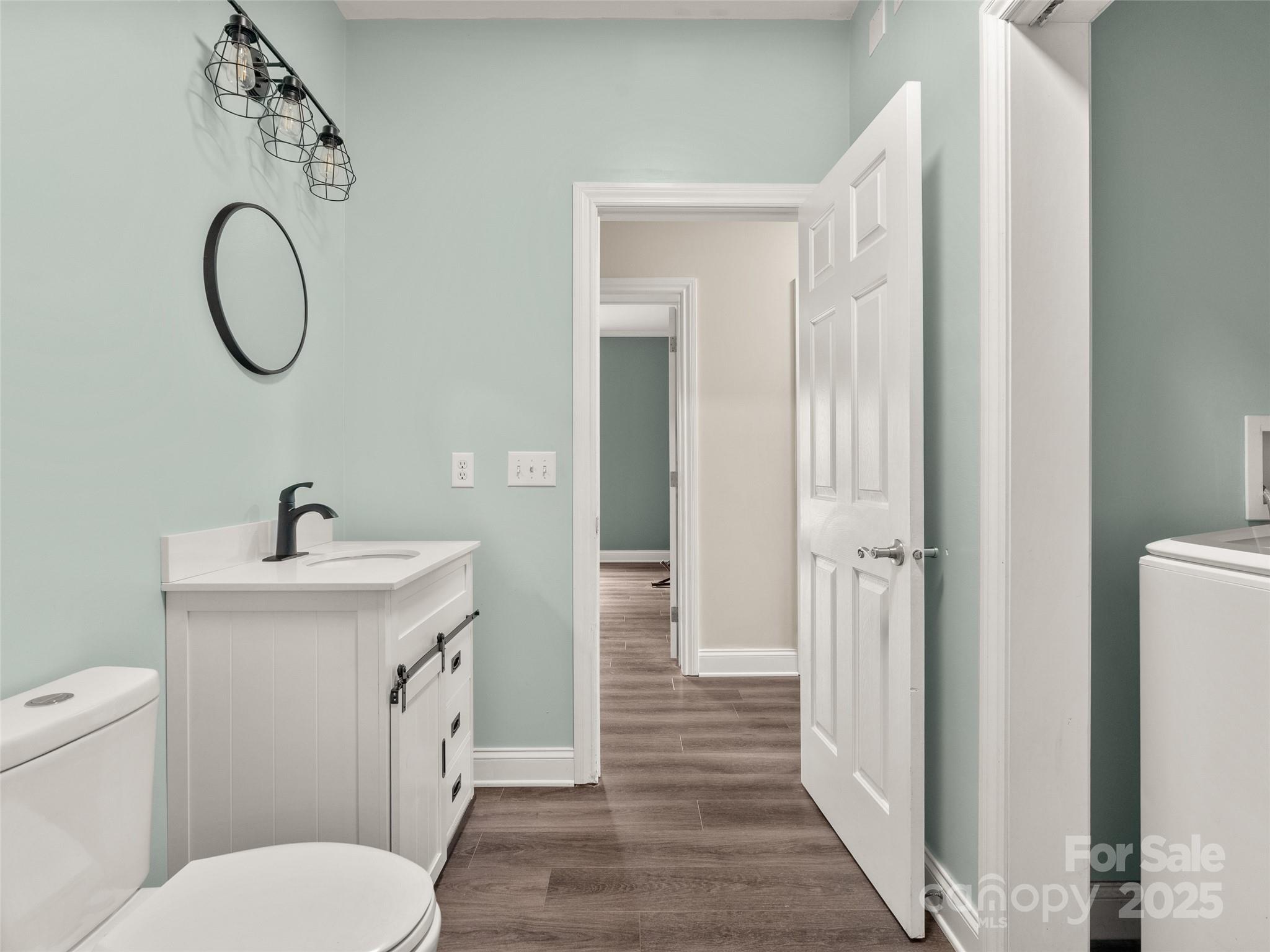 99 Curtis Parker Road Alexander, NC 28701 - Photo 16 of 24 a bathroom with a toilet a sink and a mirror