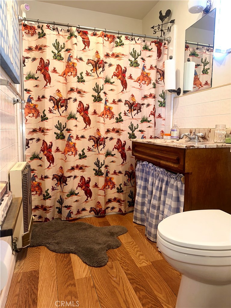 20320 Roads End Drive Perris, CA 92570 - Photo 12 of 21 a bathroom with a toilet and a shower curtain