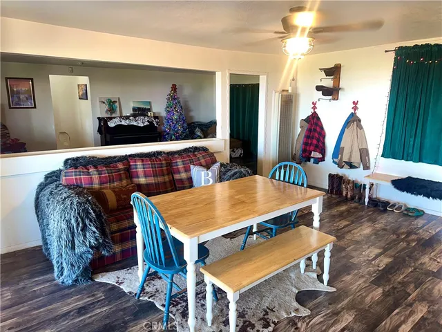 a dining room with furniture and wooden floor