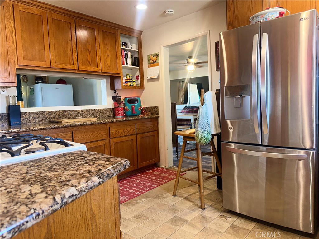 20320 Roads End Drive Perris, CA 92570 - Photo 6 of 21 a kitchen with stainless steel appliances granite countertop a refrigerator and a stove