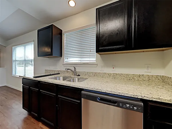 a kitchen with a sink and a wooden cabinets