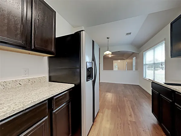 a kitchen with a refrigerator and a sink