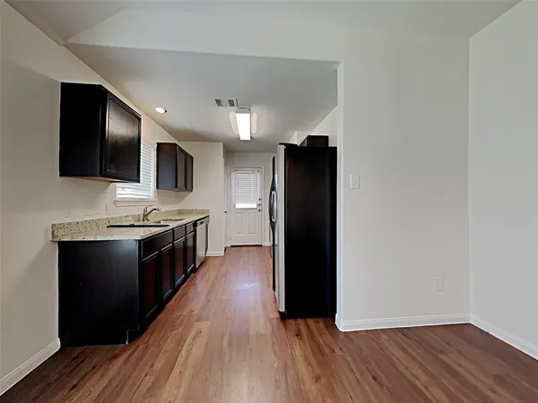 a view of kitchen with stainless steel appliances a refrigerator and a stove top oven