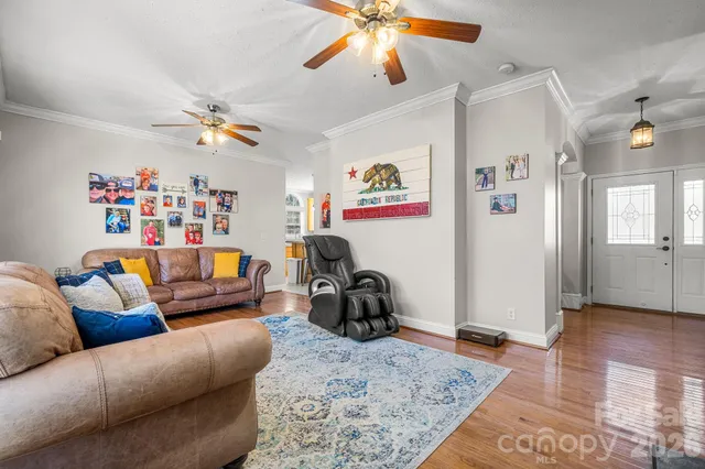 a living room with furniture and a view of kitchen