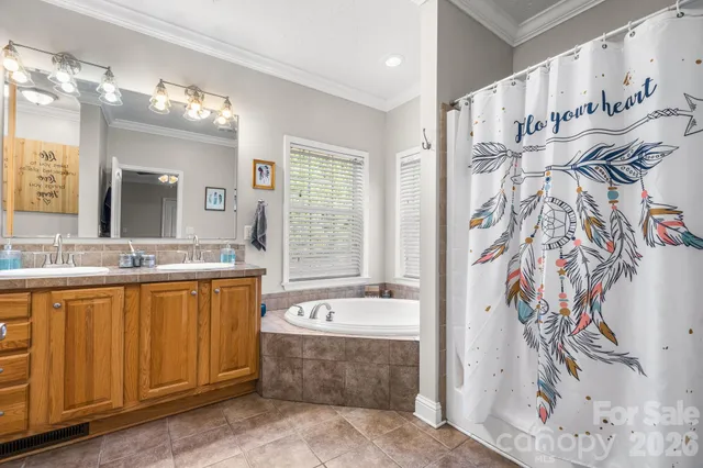 a spacious bathroom with a bathtub sink and mirror