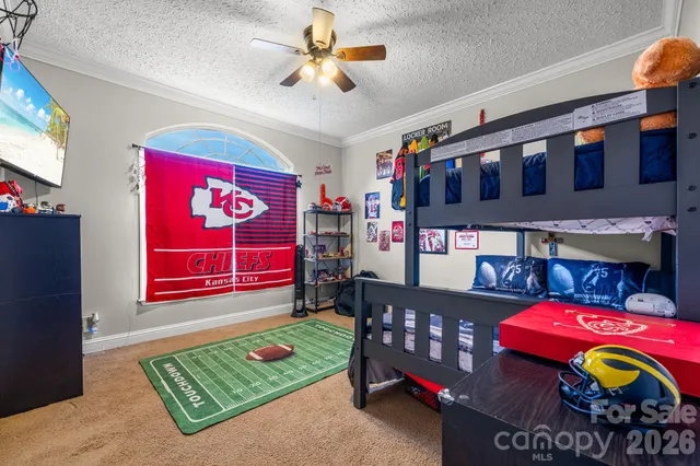 a bedroom with furniture and a lamp