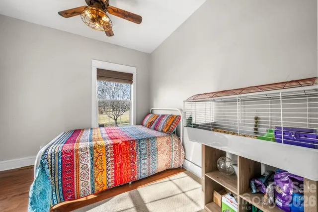a living room with a bed furniture and a window