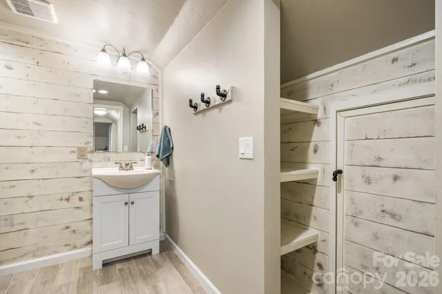 a bathroom with a sink and mirror