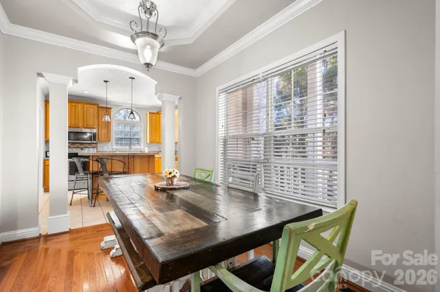 a view of a dining room with furniture window and wooden floor