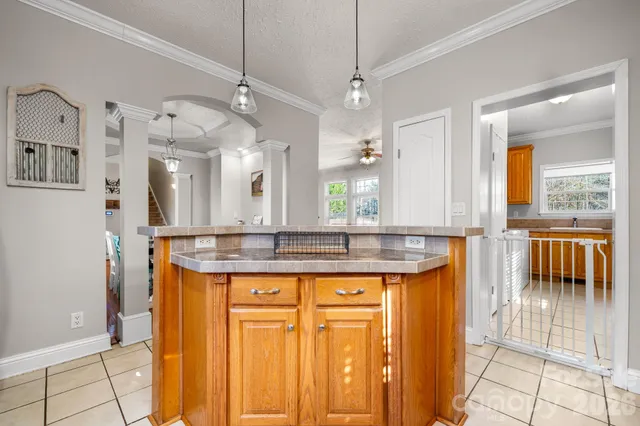 a bathroom with a granite countertop sink a mirror and a shower