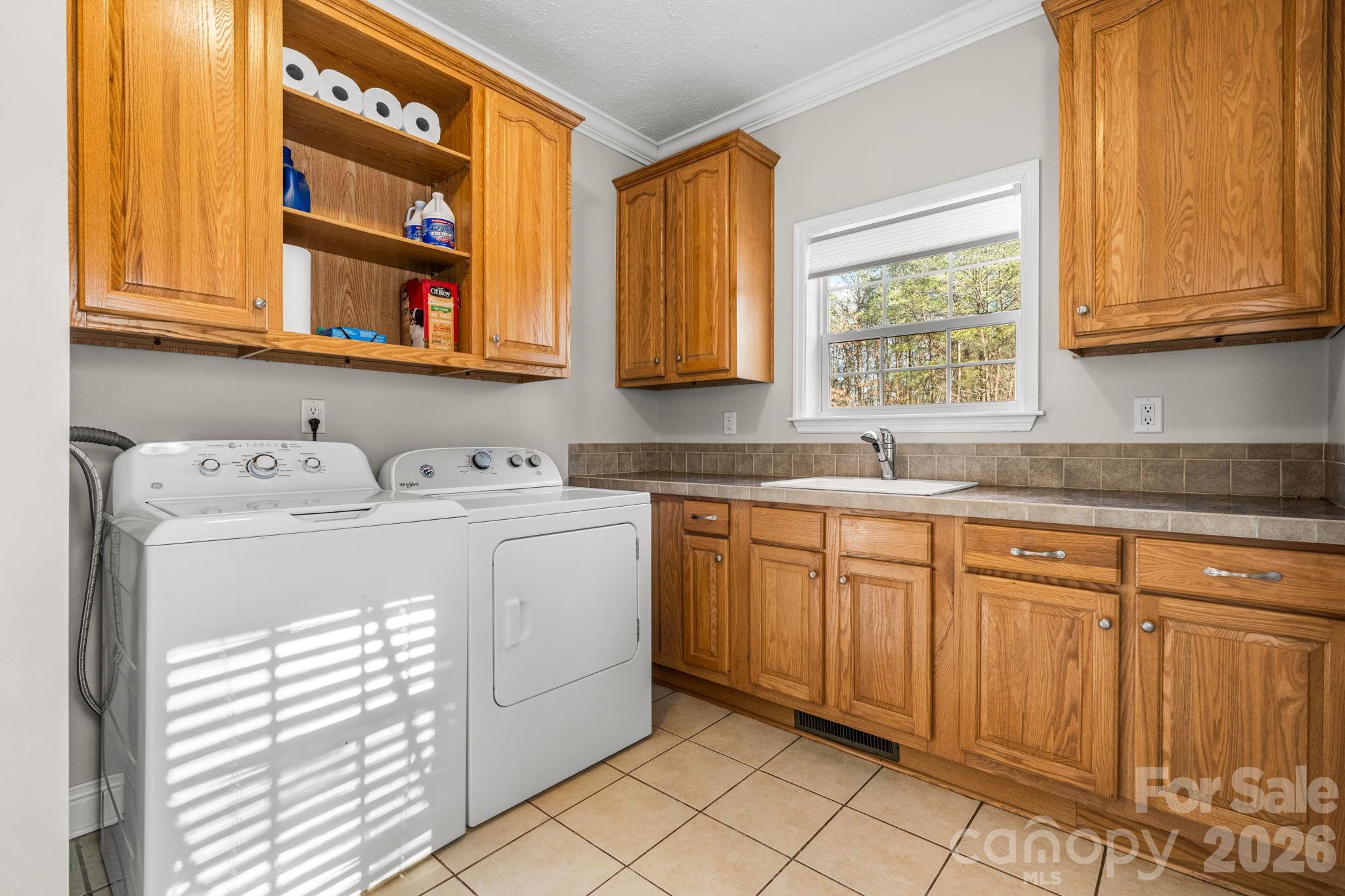 2533 Lail Road Morganton, NC 28655 - Photo 9 of 38 a utility room with cabinets washer and dryer
