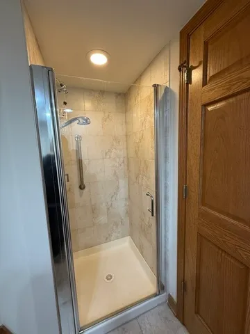 a bathroom with a shower and a tub