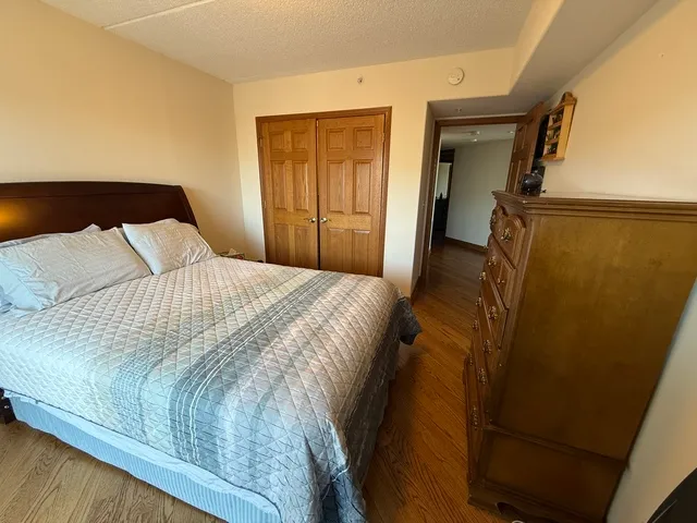 a bedroom with a bed and a dresser