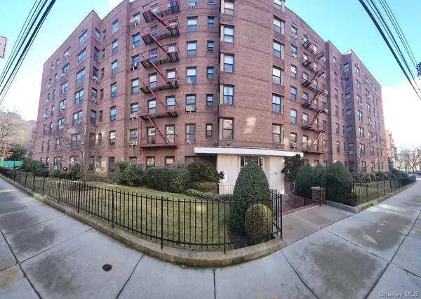 a view of a brick building next to a yard