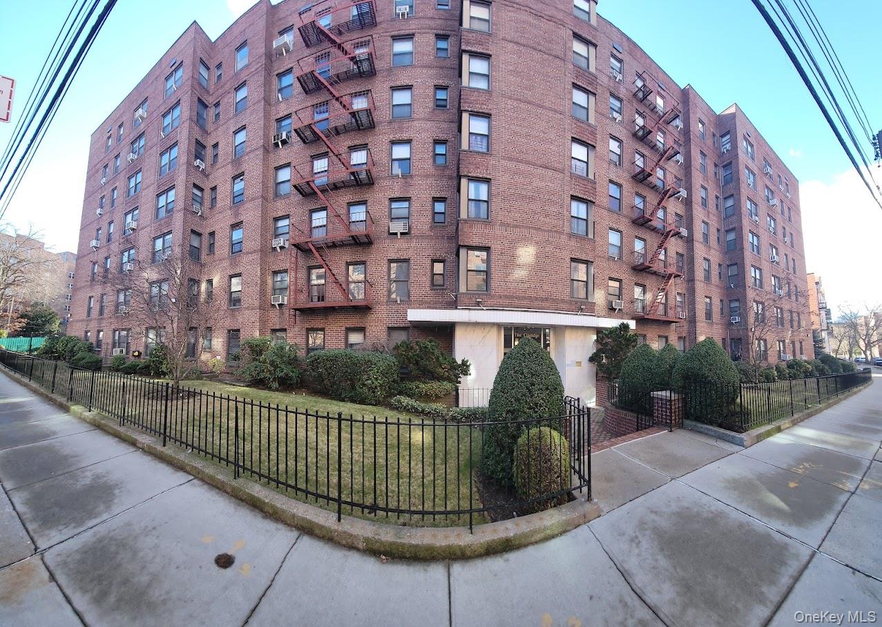 a view of a brick building next to a yard