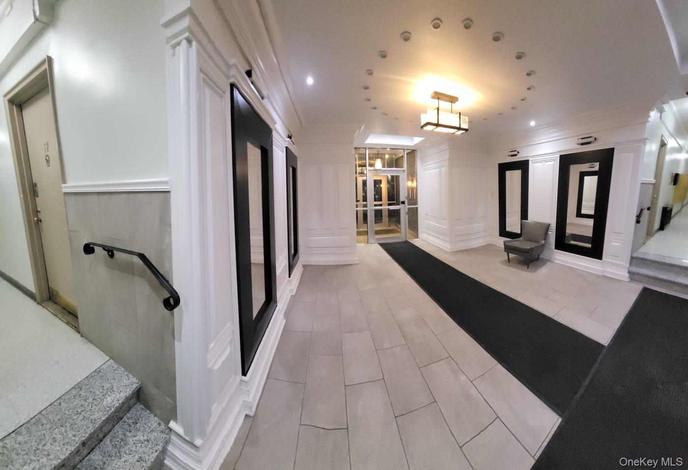 141-60 84th Road, Unit 2G Queens, NY 11435 - Photo 2 of 11 a lobby with furniture and window