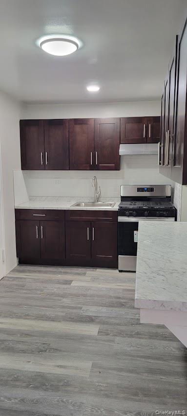 141-60 84th Road, Unit 2G Queens, NY 11435 - Photo 3 of 11 a kitchen with stainless steel appliances granite countertop a sink and cabinets