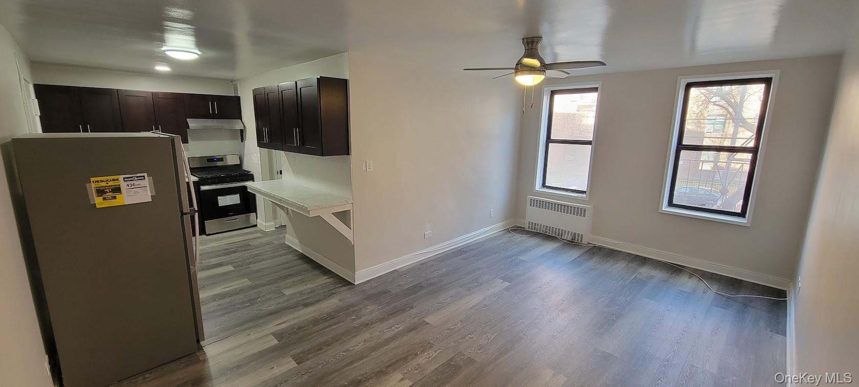 141-60 84th Road, Unit 2G Queens, NY 11435 - Photo 6 of 11 an empty room with wooden floor and windows