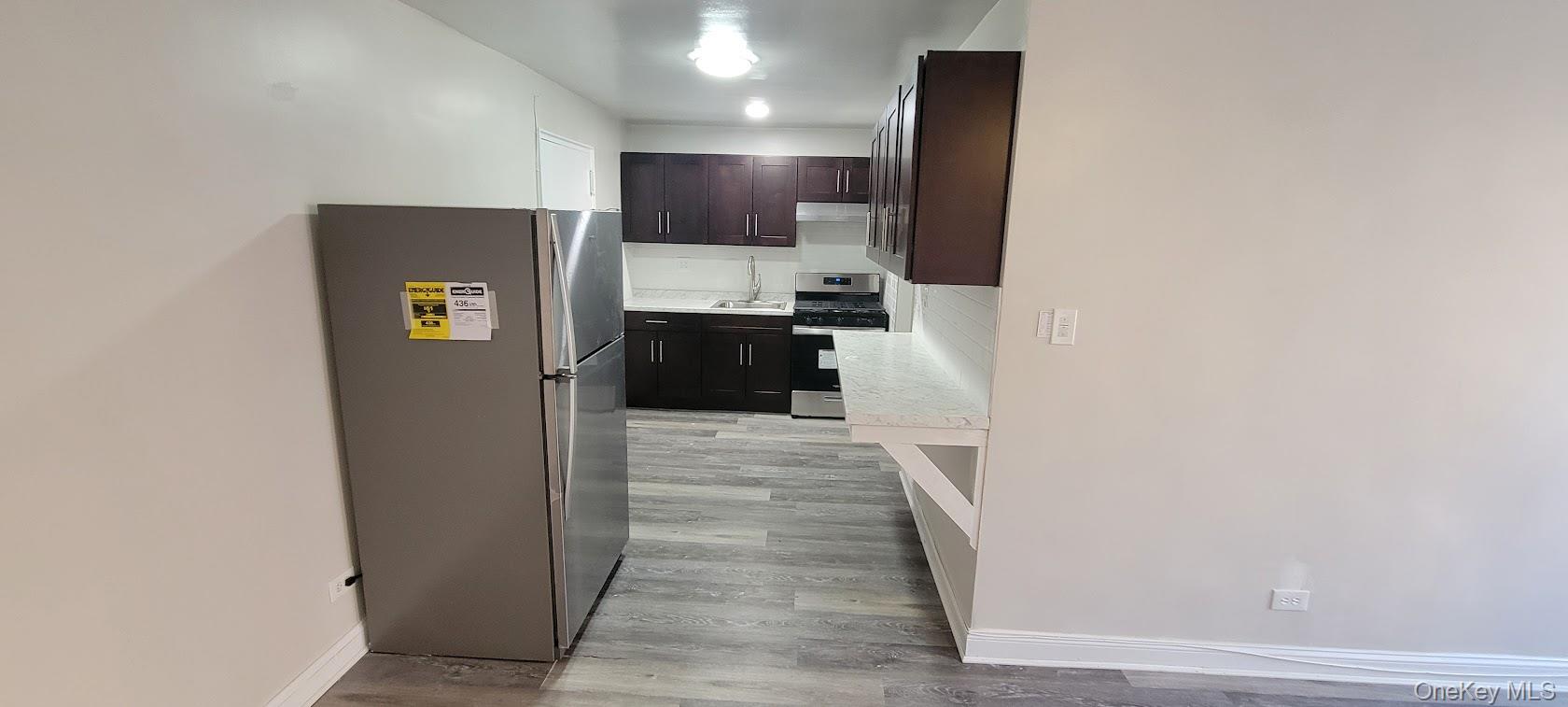 141-60 84th Road, Unit 2G Queens, NY 11435 - Photo 8 of 11 a kitchen with stainless steel appliances a refrigerator and a stove