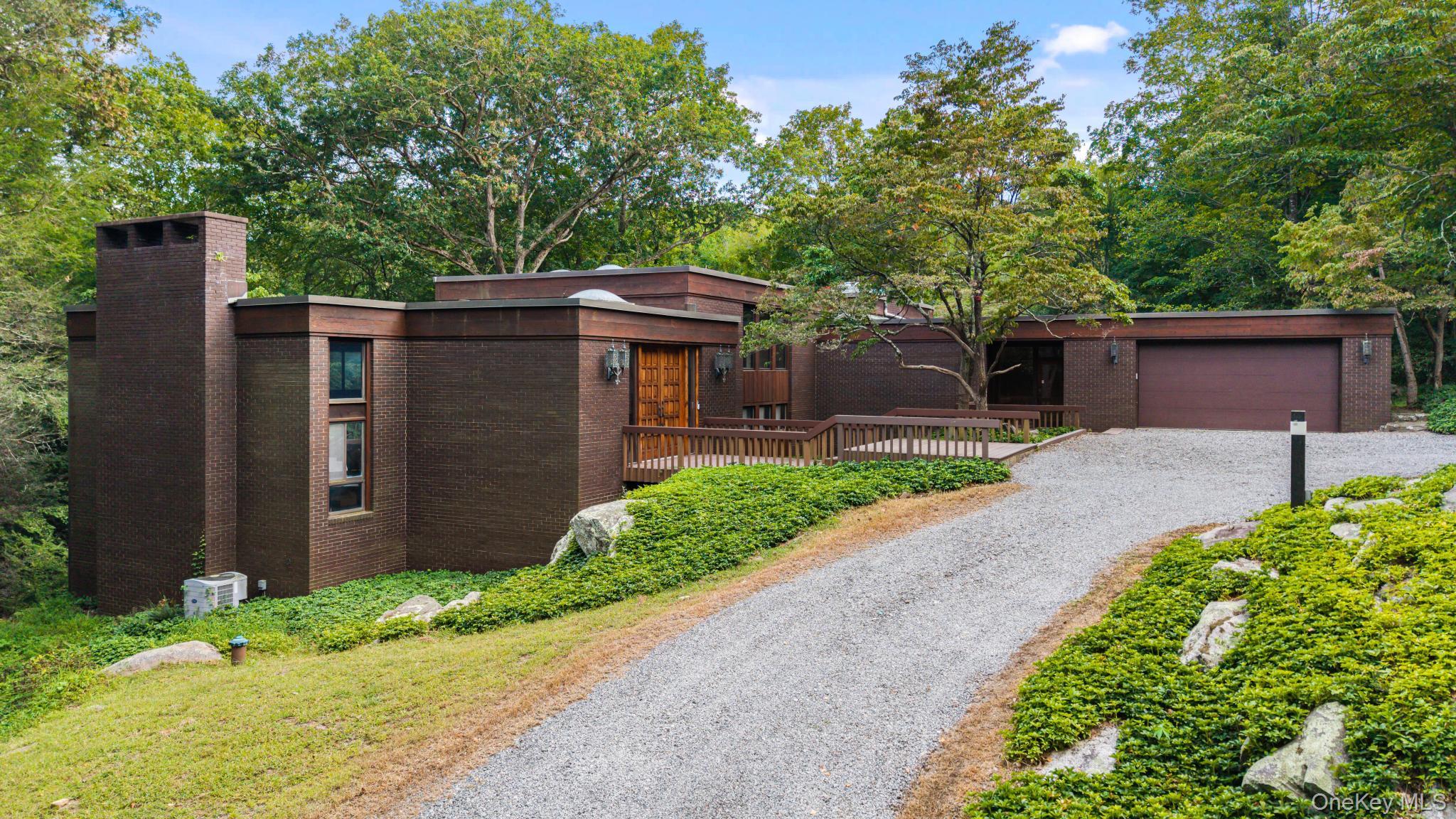 30 Upland Road South Bedford, NY 10506 - Photo 1 of 1 a front view of a house with a yard and potted plants