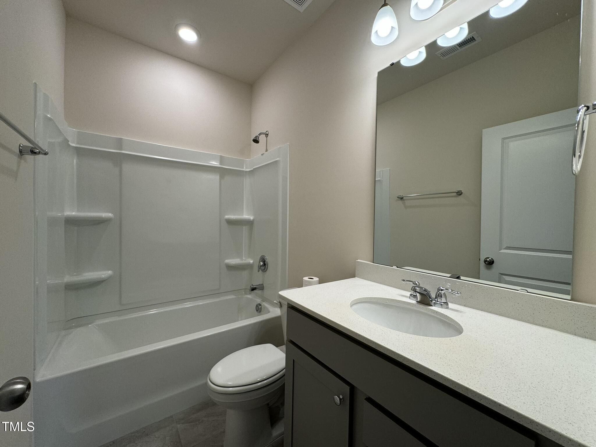 128 Katrine Way Raleigh, NC 27603 - Photo 11 of 34 a bathroom with a sink toilet vanity and shower