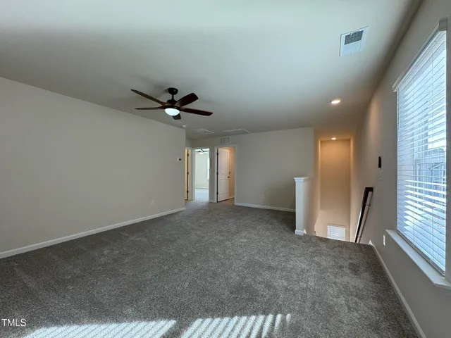 a view of an empty room and a window
