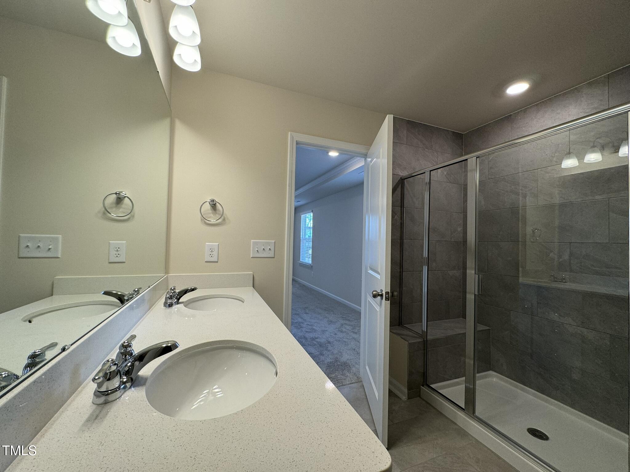 128 Katrine Way Raleigh, NC 27603 - Photo 18 of 34 a bathroom with a sink a toilet and shower