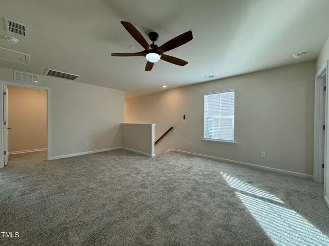 a view of a livingroom with a ceiling fan and window