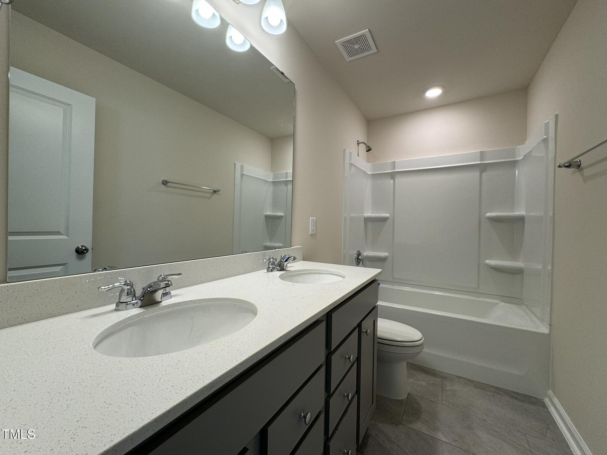 128 Katrine Way Raleigh, NC 27603 - Photo 24 of 34 a bathroom with a sink a toilet a mirror and shower