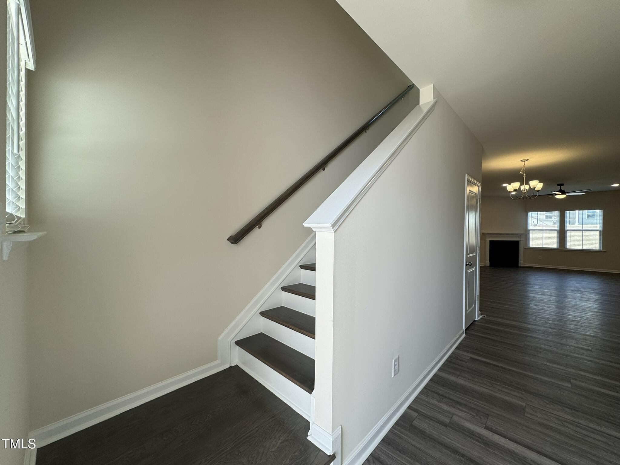 128 Katrine Way Raleigh, NC 27603 - Photo 3 of 34 a view of a hallway with wooden floor and staircase
