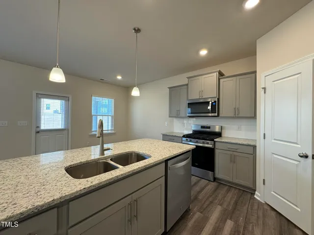 a kitchen with a sink appliances and cabinets