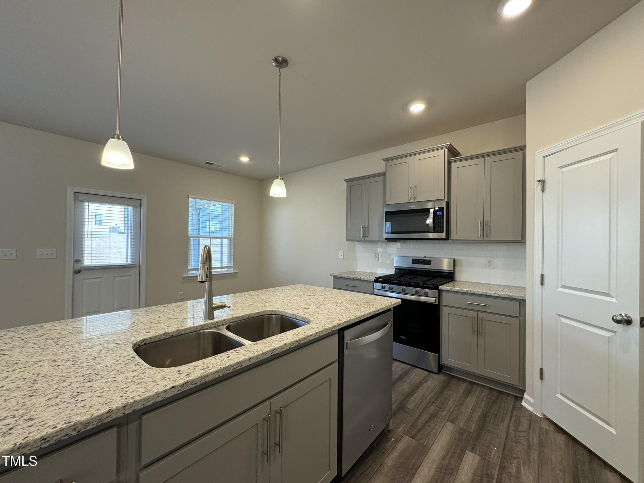128 Katrine Way Raleigh, NC 27603 - Photo 8 of 34 a kitchen with a sink appliances and cabinets