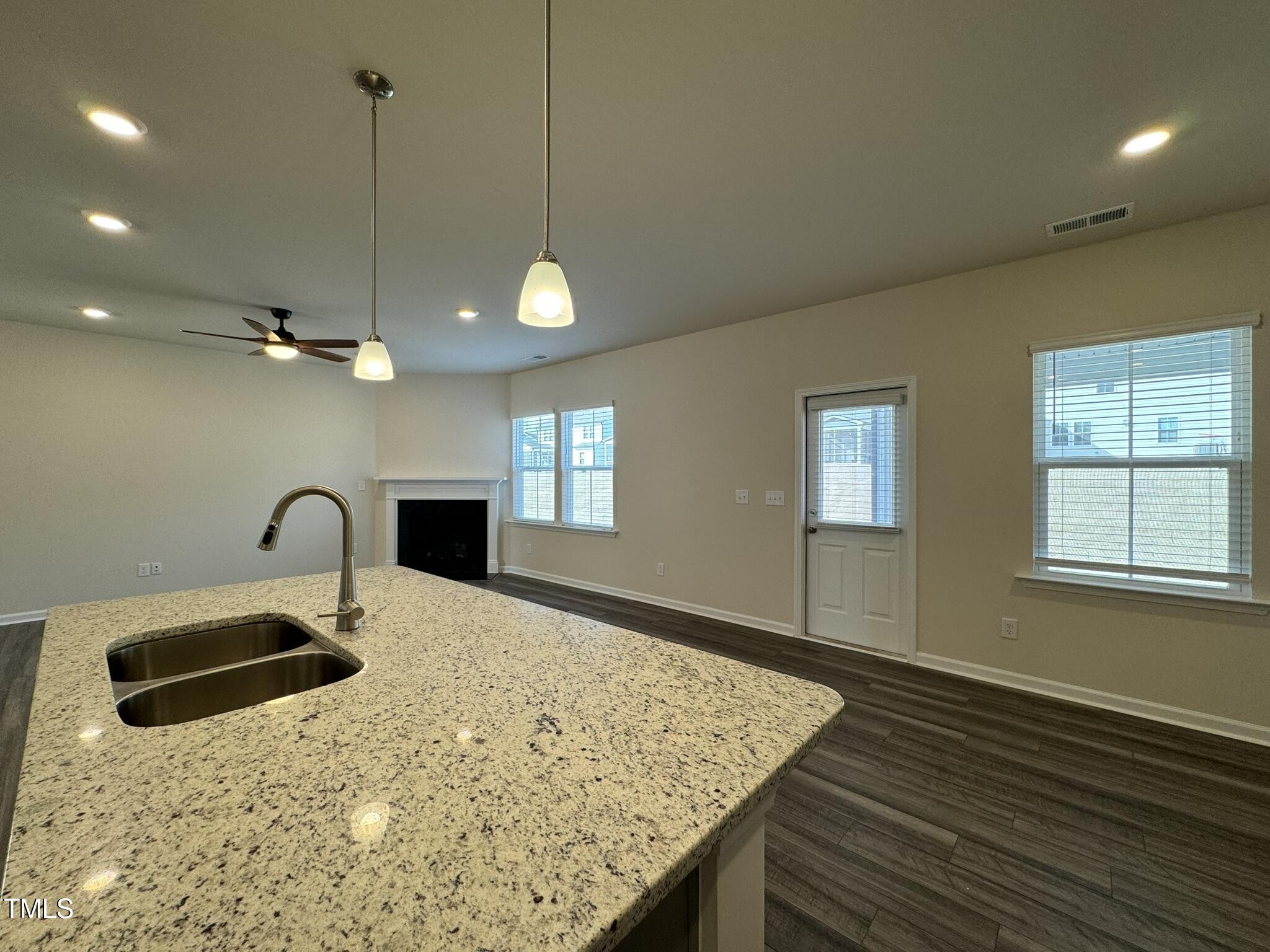 128 Katrine Way Raleigh, NC 27603 - Photo 9 of 34 a kitchen with kitchen island a sink stainless steel appliances and window