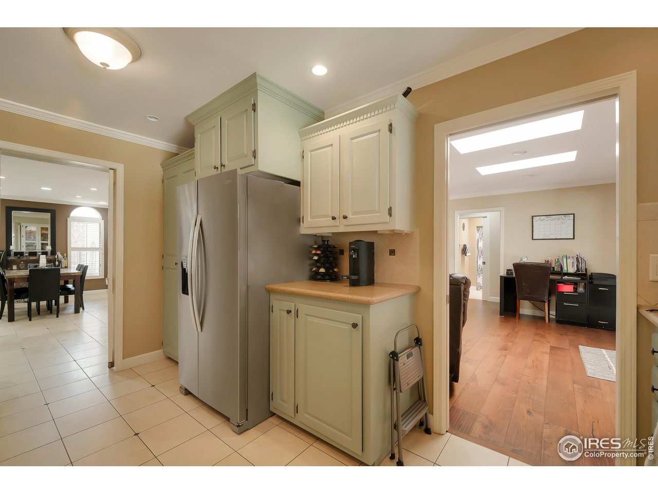 1009 47th Avenue Greeley, CO 80634 - Photo 8 of 30 a kitchen with refrigerator and cabinets