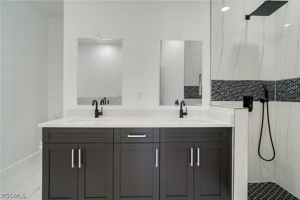 a bathroom with a sink and mirror