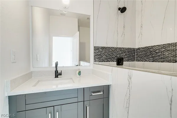 a bathroom with a sink and a mirror