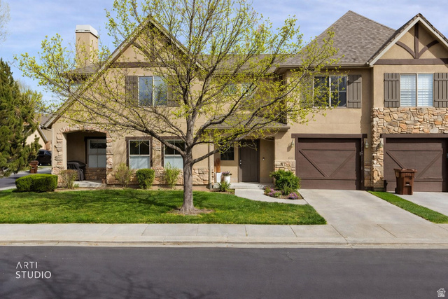 959 East 6795 South Midvale, UT 84047 - Photo 1 of 1 Tudor home featuring stone siding, stucco siding, an attached garage, and a chimney