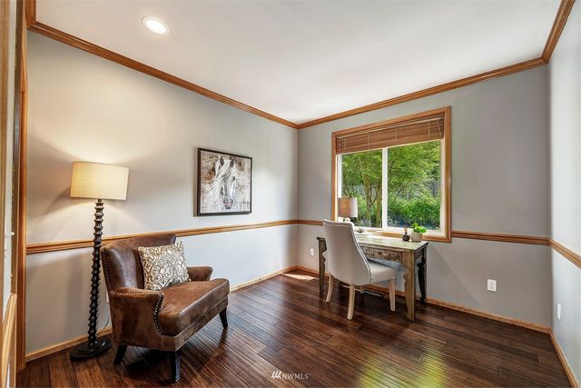 a dining room with furniture and wooden floor