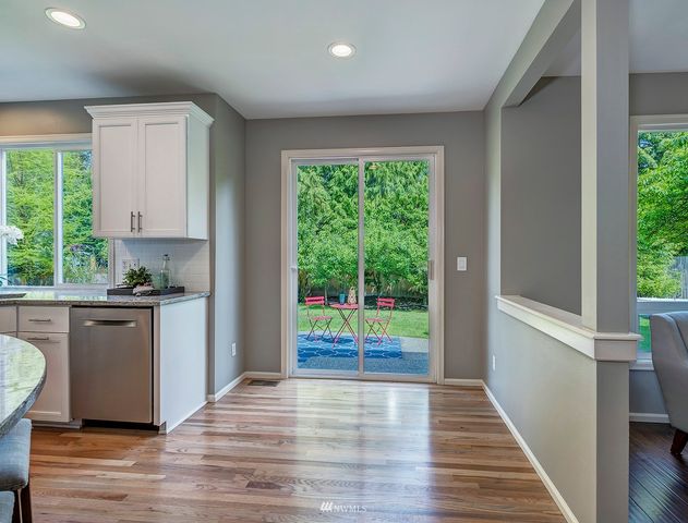 a kitchen with a wooden floor and a window