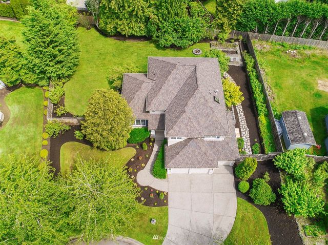 an aerial view of a house with a yard basket ball court and outdoor seating