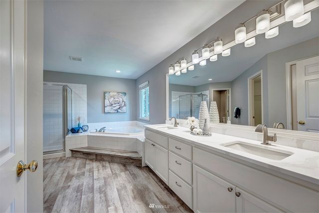 a spacious bathroom with a double vanity sink and a mirror