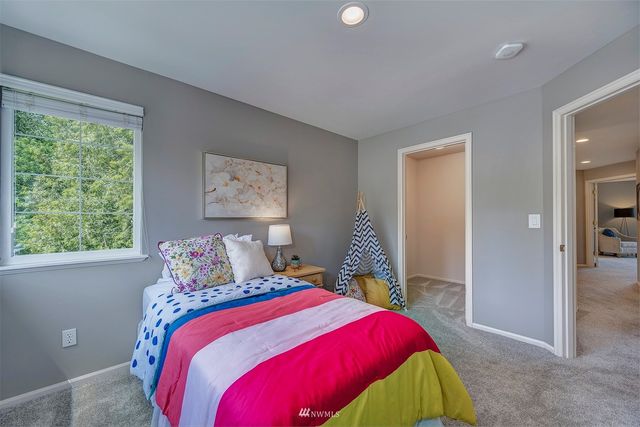 a bedroom with a bed and window