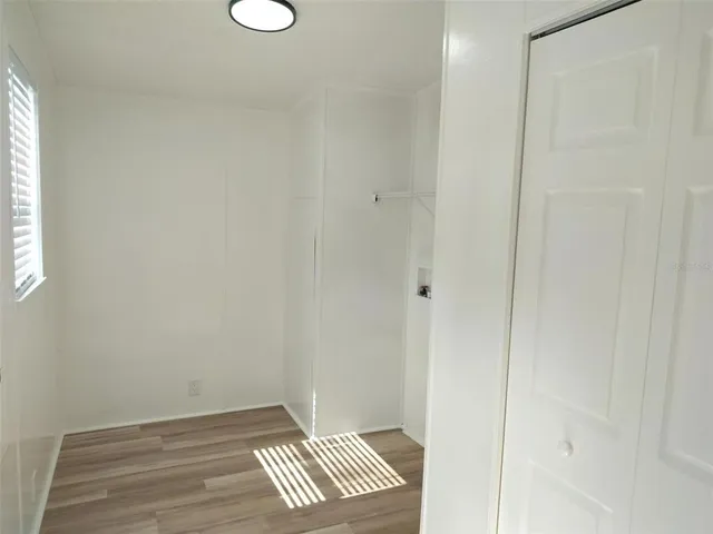 a view of wooden floor and windows in a room
