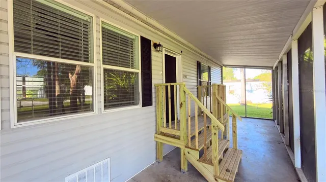 a view of an entryway with wooden floor and door