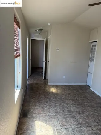 a view of a hallway with wooden shelves