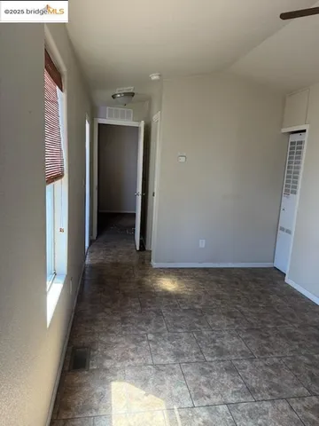 a view of a hallway with wooden shelves
